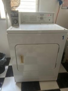 a white dishwasher with a microwave on top of it at Bicentenario Park Apartment in El Cerrillo
