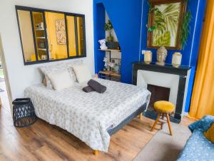 a bedroom with a bed and a fireplace at Le Terrazza - 1P à 2P Terrasse - Henriville in Amiens