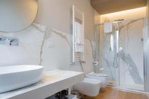 a bathroom with a sink and a shower and a toilet at Villa Galentino Suite Room in Trani