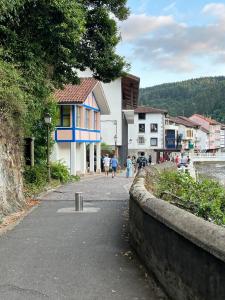 a street in a town with people walking down the street at Salabardoa Ea in Ea