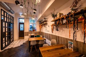 um restaurante com mesas de madeira e bancos numa sala em Prague Dream Hostel em Praga