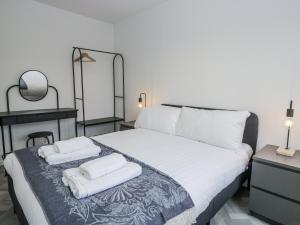 a bedroom with a bed with two towels on it at Claife Flights in Bowness-on-Windermere