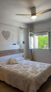a bedroom with a bed and a ceiling fan at Masia Bernat in Tortosa