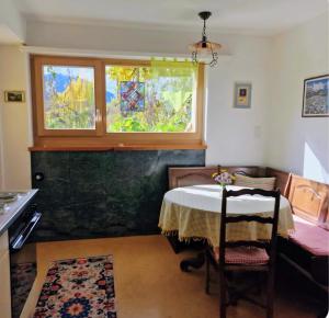 a dining room with a table and a window at Arve in Bitsch