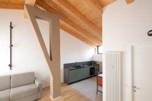 a living room with a couch and a sink at Ivrea Centro - Attico Top in Ivrea