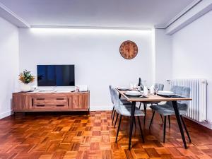 a dining room with a table and a tv at El Balcón de Machado in Soria