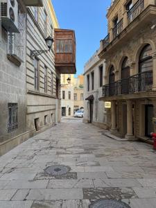 an empty street in a city with buildings at Caspian Hostel in Baku