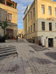 an empty street with two buildings and a building at Caspian Hostel in Baku
