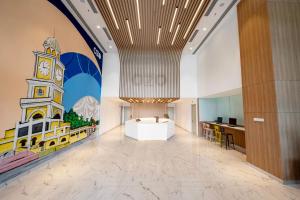 a lobby with a clock tower painted on the wall at OZO Medini Malaysia in Nusajaya