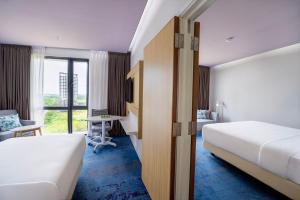 Ένα ή περισσότερα κρεβάτια σε δωμάτιο στο OZO Medini Malaysia