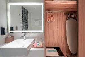 a bathroom with a sink and a mirror at OZO Medini Malaysia in Nusajaya +40 photos
