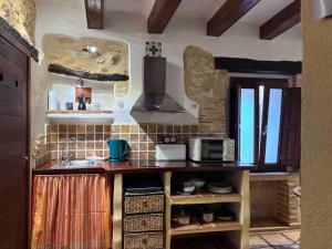 una cocina con encimera y microondas en No3 CasaTosca Javea -Apart muy acogedor en el centro del Casco Antiguo, en Jávea
