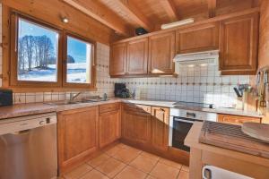 una grande cucina con armadi in legno e una finestra di Chalet Berrier a Le Grand-Bornand