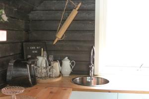 a kitchen counter top with a sink and a counter top at Åsjord Farmhouse in Oldra