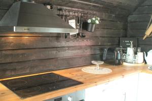 a kitchen with a wooden counter top with a stove at Åsjord Farmhouse in Oldra