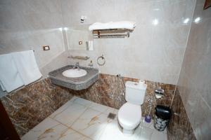 a bathroom with a white toilet and a sink at Osman House Luxor in Luxor +13 photos