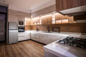 a kitchen with wooden cabinets and a stove top oven at شاليه مسا الفندقي in Buraydah