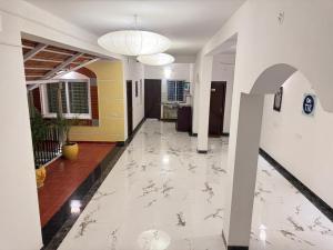 pasillo de un edificio con suelo de baldosa blanca en La Coromandel Luxury - TIE, en Pondicherry