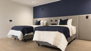 Postel nebo postele na pokoji v ubytování Hotel Boutique Ubuntu