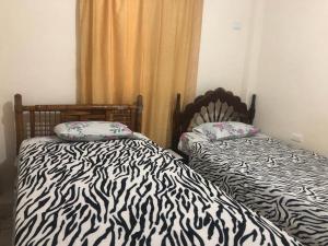 Postel nebo postele na pokoji v ubytování hospedaje Maluli 04