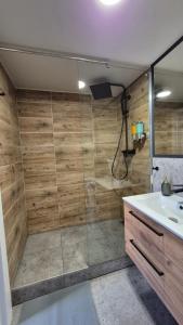 a bathroom with a shower and a sink at Apart Complex Green Rewolucji 27 in Łódź +61 photos