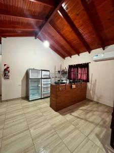 a large room with a kitchen with a table and a counter at Complejo turístico Anto in Puerto Rico