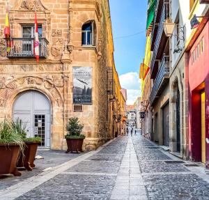 an empty street in a city with buildings at El Balcón de Machado in Soria