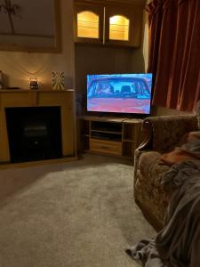 a living room with a flat screen tv and a couch at My happy place in Greencastle +11 photos