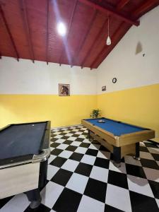 a room with a pool table and a checkered floor at Complejo turístico Anto in Puerto Rico +17 photos