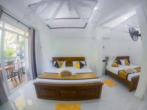 Postel nebo postele na pokoji v ubytování Pearl Vista Ella