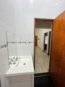 a bathroom with a white sink and a mirror at Complejo turístico Anto in Puerto Rico