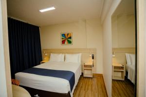 Postel nebo postele na pokoji v ubytování Luds Comfort Hotel