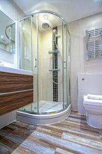 a bathroom with a shower and a toilet at Imperial Court Studios in London