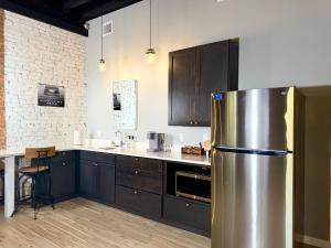 a kitchen with a stainless steel refrigerator in it at The Benjamin Hotel in Watkins Glen