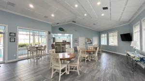a dining room with a table and chairs at Seashell Escape in New Smyrna Beach