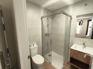 a bathroom with a shower and a toilet and a sink at HeyWelcome Valladolid Centro in Valladolid