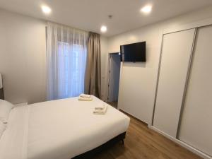 a bedroom with a large white bed and a window at HeyWelcome Valladolid Centro in Valladolid