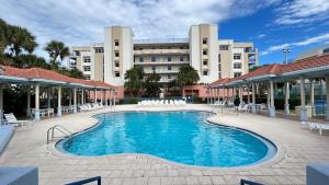 a swimming pool in front of a large building at Seashell Escape in New Smyrna Beach