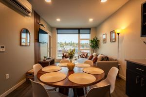 a dining room with a table and a living room at Heart of Downtown Apt with City View, Walkable to HotSpots in Spokane