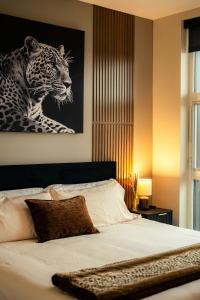a bedroom with a bed with a picture of a leopard at Heart of Downtown Apt with City View, Walkable to HotSpots in Spokane