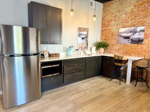 a kitchen with a stainless steel refrigerator and a table at The Benjamin Hotel in Watkins Glen +54 photos