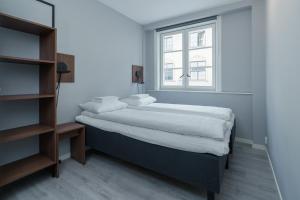 a bedroom with two beds and a window at MAYA Apartments - Sentrum in Oslo