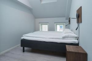 a bedroom with a bed and a wooden table at MAYA Apartments - Sentrum in Oslo