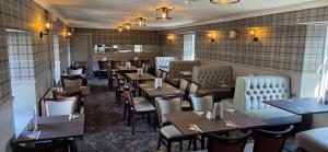 a restaurant dining room with tables and chairs at The Famous Star Hotel Moffat in Moffat +28 photos