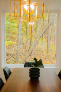 a dining room table with a view of a window at The Greenhouse with Indoor Slide close to Hocking Hills in South Bloomingville +120 photos