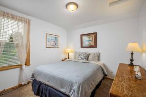 a bedroom with a bed and a window at Twin Rocks Hideaway in Rockaway Beach