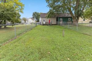 a chain link fence in front of a yard at Simple Comfort 1 Bed 1 Bath Near Downtown Indy in Indianapolis