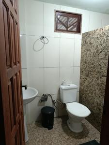 a bathroom with a toilet and a sink at Pousada Nosso Cantinho in Guarapari