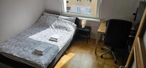 a small bed in a room with a desk and a window at Apartament Gdynia Babie Doły in Gdynia +27 photos