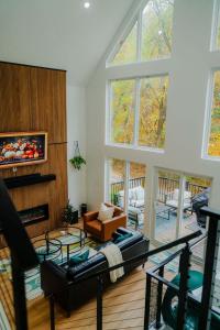 a living room with a couch and a fireplace at The Greenhouse with Indoor Slide close to Hocking Hills in South Bloomingville